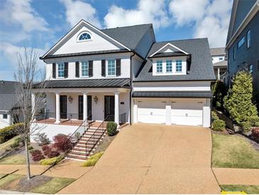 Stunning two-story white brick home with a two-car garage and beautiful landscaped front yard at 3020 Barnes Mill Ct, Roswell, GA 30075