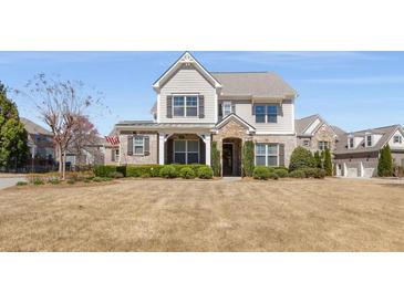 Charming two-story home featuring manicured landscaping, a stone-accented entrance, and neutral siding at 2564 Lulworth Ne Ln, Marietta, GA 30062