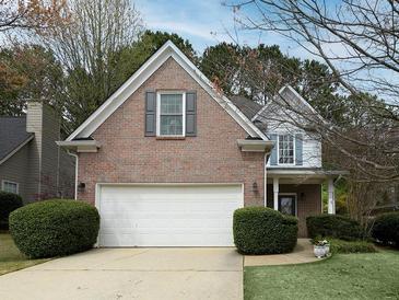 Charming two-story brick home featuring a two-car garage and well-maintained landscaping and a covered front porch at 2158 Berryhill Se Cir, Smyrna, GA 30082