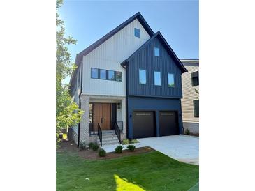 Beautiful two-story home with a two car garage and a well manicured lawn on a sunny day at 2587 Apple Valley Rd, Brookhaven, GA 30319