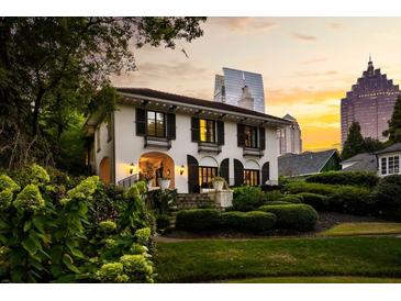 Stunning two-story home with manicured landscaping and a picturesque city view at sunset at 31 Lafayette Ne Dr, Atlanta, GA 30309