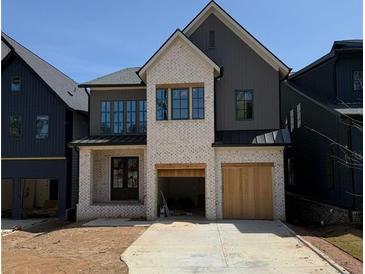 New construction shows a modern two-story home with white brick and a two-car garage at 2583 Apple Valley Rd, Brookhaven, GA 30319