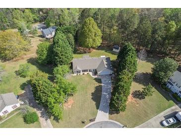 Expansive aerial view of a charming ranch home with a long drive and lush green trees at 313 Ridge Hill Cir, Canton, GA 30115