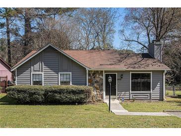 Charming single-story home with a combination of siding and stone, manicured lawn, and a welcoming entrance at 910 Brandon Hill Way, Jonesboro, GA 30238