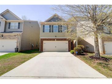 Charming two-story home featuring a two-car garage and manicured front lawn at 2205 Capella Sw Cir, Atlanta, GA 30331