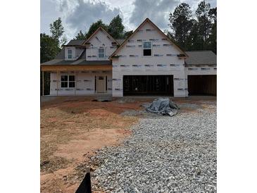 New construction home featuring a two-story design and an attached two-car garage at 210 Pinewood Dr, Covington, GA 30014