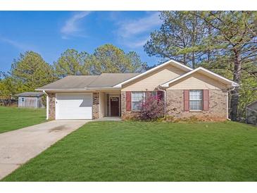 Charming single-story brick home with a well-manicured lawn and attached two-car garage at 520 Crick Pt, Palmetto, GA 30268