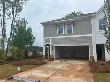 A beautifully designed two-story townhome with a two-car garage and manicured lawn at 101 Priestwood Ln, Acworth, GA 30102