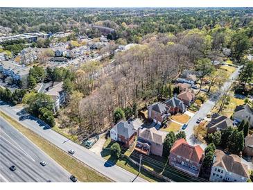 An aerial view showing a neighborhood with mature trees and various home styles at 1734 Summit Glen, Atlanta, GA 30329