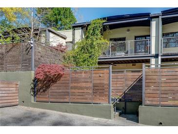 Modern townhome featuring horizontal wood-slat fence and a private balcony at 1791 Harper Nw St # H, Atlanta, GA 30318