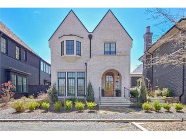 Charming two-story home with white brick, an arched entry, manicured landscaping and welcoming curb appeal at 250 4Th St, Fayetteville, GA 30214