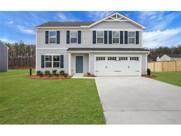 Charming two-story home with a well-manicured lawn and a two-car garage at 8470 Limerick Lane Dr, Winston, GA 30187