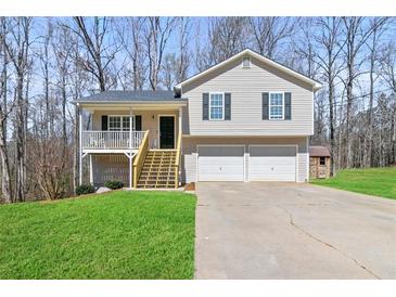 Charming two-story home featuring a welcoming front porch and a two-car garage at 38 Wayfaring Ct, Rockmart, GA 30153