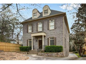 Charming gray brick home with a manicured lawn and classic architectural details at 1109 Pine Grove Ne Ave, Brookhaven, GA 30319