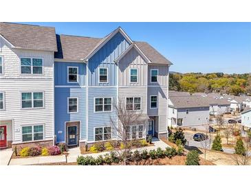 New construction townhouse with blue and gray siding, manicured landscaping, and inviting curb appeal at 82 Rising Fawn Ln, Marietta, GA 30060