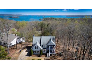 Inviting two-story house featuring a charming porch and scenic lake views at 7492 Shadburn Ferry Rd, Cumming, GA 30041