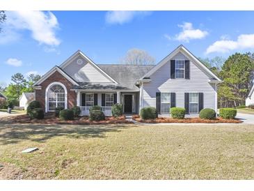 Charming single-story home boasts a well-manicured lawn and inviting curb appeal with classic design elements at 1056 Fern Valley Way, Dacula, GA 30019