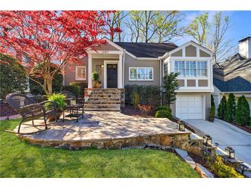 Charming home with stone patio, lush lawn, and vibrant trees at 1287 University Ne Dr, Atlanta, GA 30306