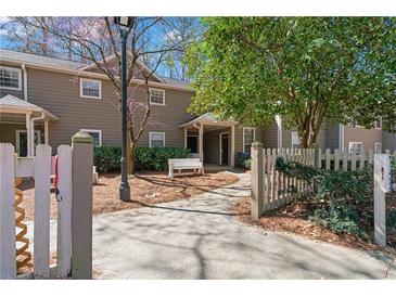 Inviting townhouse exterior with a charming walkway and a cozy front bench at 2209 N Forest Trl, Dunwoody, GA 30338