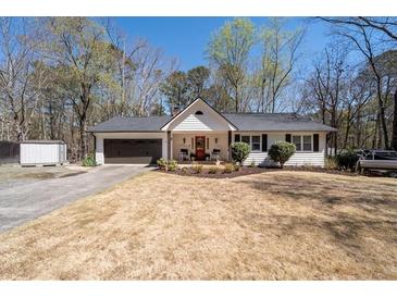 Charming single-Gathering home with a well-manicured lawn, an attached garage, and a cozy front porch at 116 Myrtle Rd, Woodstock, GA 30189