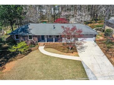 Charming single-story home with well-maintained lawn, driveway, and welcoming front porch at 1564 Pedro Sw Dr, Mableton, GA 30126