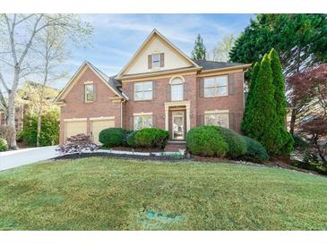 Charming two-story brick home with well-manicured lawn and a two-car garage at 4370 Landover Way, Suwanee, GA 30024