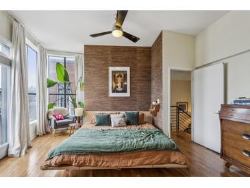 Well decorated bedroom with a textured accent wall and a fan on the ceiling at 307 Cherokee Se Ave # 3, Atlanta, GA 30312