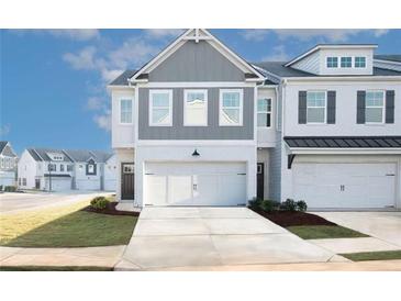 Charming two-story townhome with attached garages and modern architectural design at 2698 Ne Almand Ne Ln, Conyers, GA 30013
