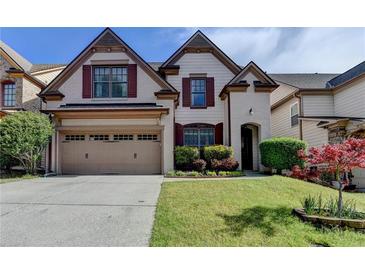 Charming two-story home with a two-car garage, brick accents, and a well-manicured front lawn at 3517 Harvest Ridge Ln, Buford, GA 30519