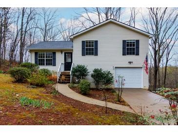 Charming home with neatly landscaped front yard, sidewalk, and black shutters at 67 Red Top Cir, Emerson, GA 30137