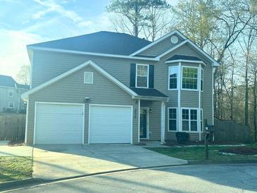 Charming two-story home with a two-car garage and manicured lawn at 4578 Carriage Park Dr, Lithonia, GA 30038