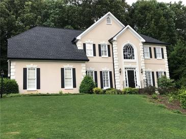 Elegant two-story home with manicured lawn, black shutters and decorative trim at 1201 Lake Washington Dr, Lawrenceville, GA 30043