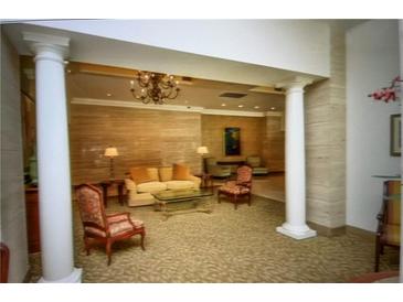 Beautifully decorated lobby with chandelier, columns, seating area, and natural light at 300 Peachtree Ne St # 9A, Atlanta, GA 30308
