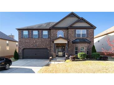 Charming two-story brick home with a well-manicured lawn and attached garage, perfect for Gathering living at 817 Nevis Way, Mcdonough, GA 30253