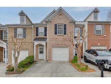 Charming brick townhome with a one-car garage and manicured landscaping at 3826 Dandridge Way, Duluth, GA 30096