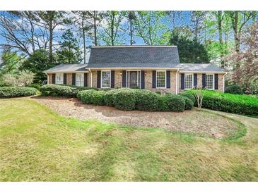 Charming brick home featuring manicured landscaping and a well-maintained front yard at 3474 Castleridge Dr, Tucker, GA 30084