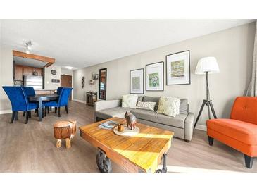 Cozy living room featuring modern decor, neutral tones, and an open concept design with an adjacent dining area at 375 Ralph Mcgill Ne Blvd # 502, Atlanta, GA 30312