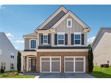 Charming two-story home boasts brick accents, a two-car garage, and a well-manicured lawn in a suburban setting at 6015 Crestwick Way, Cumming, GA 30040
