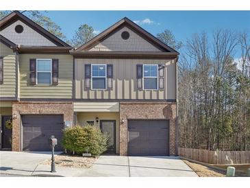 Charming townhome with a brick facade, private garage, and well-maintained landscaping at 1901 Creel Ln, Atlanta, GA 30349