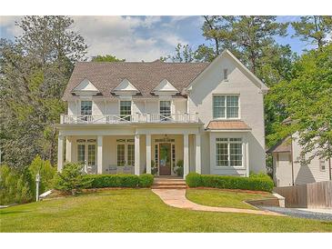 Charming two-story home with a covered front porch, landscaped yard, and a welcoming entrance at 891 Glenbrook Nw Dr, Atlanta, GA 30318