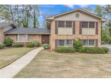 Charming two-story brick home with mature landscaping and a well-maintained front yard at 3347 Stonecrest Ct, Atlanta, GA 30341