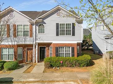 Charming two-story townhome with gray siding, brick accents, and well-maintained landscaping at 4917 Walden Lake Sq, Decatur, GA 30035