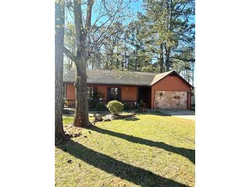 Charming single-story home featuring a stone accent garage and well-maintained front yard at 5687 Pine Meadow Ct, Morrow, GA 30260