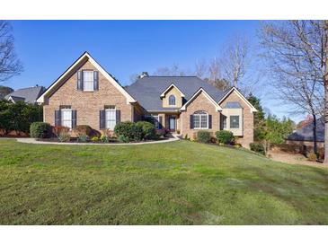 Charming brick home with well-manicured lawn and mature landscaping at 2667 White Rock Dr, Buford, GA 30519