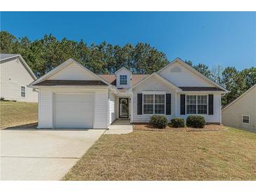 Charming single-Gathering home featuring a well-maintained lawn and an attached one car garage at 539 Creekview Overlook, Stockbridge, GA 30281