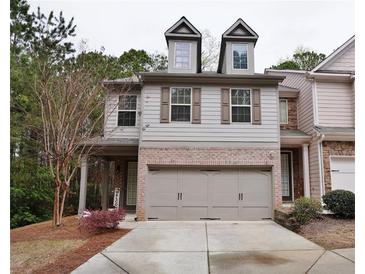 Two-story home with two car garage, brick accents and gable windows at 2620 Sardis Chase Court, Buford, GA 30519