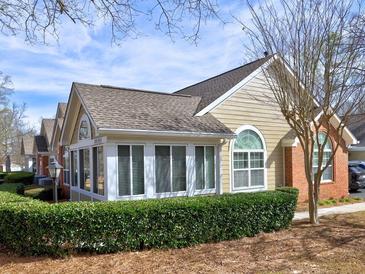 Charming home featuring a sunroom, well-maintained landscaping, and a cozy, inviting facade at 2730 Vintage Reserve Ln, Marietta, GA 30066