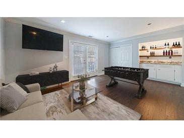 Cozy living space featuring a foosball table, bar area, and access to outdoor space through French doors at 13 Ivy Ne Sq, Atlanta, GA 30342