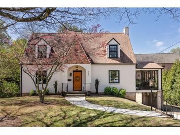 Charming brick home with a colorful front door and well-manicured landscaping at 950 Clairemont Ave, Decatur, GA 30030