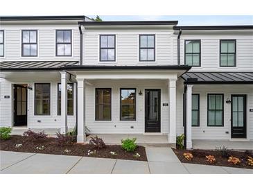 Charming townhome with white siding, black trim, and inviting front porch at 58 Black Gum Ln # 47, Auburn, GA 30011